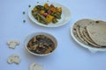 Flat lay of matar paneer veg, mashroom soup and roti Indian food.