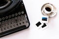 Flat lay of mechanical typewriter with espresso and film slides