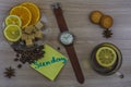 Flat lay. Men`s watches with leather strap. Sticker with inscription Sunday. Cup of tea with lemon. Slices of lemon and orange on