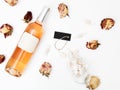 Flat lay. Minimal style. Minimalist trend photography. A bottle of rose with a composition of dried roses. Wine bottle