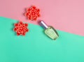 Flat lay minimalism of a perfume bottle and candles in the form of flowers on a pastel background