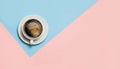 Flat lay of minimalistic picture of coffee on pink and yellow background.