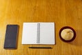 Flat lay minimalistic work place. Wood office desk table with notebook, pen and a fruit