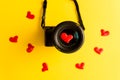 Flat lay of mirorless camera with lens and love red hearts on yellow background, engagement or couple wedding Royalty Free Stock Photo