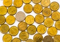 Flat lay of mixed yellow-gold Polish coins with one silver coin of higher face value isolated on white background.