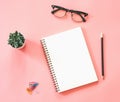 Flat lay mockup design of workspace desk with blank notebook, smartphone, coffee, stationery on pink pastel color with copy space Royalty Free Stock Photo