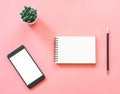 Flat lay mockup design of workspace desk with blank notebook, smartphone, coffee, stationery on pink pastel color with copy space Royalty Free Stock Photo