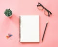 Flat lay mockup design of workspace desk with blank notebook, smartphone, coffee, stationery on pink pastel color with copy space Royalty Free Stock Photo