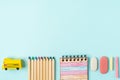 Flat lay of modern bright blue office desktop with school supplies on table around empty space for text. Top view Back to school Royalty Free Stock Photo