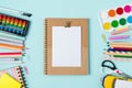 Flat lay of modern bright blue office desktop with school supplies on table around empty space for text. Top view Back to school Royalty Free Stock Photo