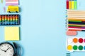 Flat lay of modern bright blue office desktop with school supplies on table around empty space for text. Top view Back to school Royalty Free Stock Photo