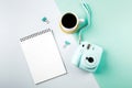 Flat lay with modern mini camera, empty notebook and cup of coffee. Fashion blogger, minimal concept Royalty Free Stock Photo