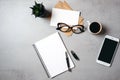 Flat lay modern minimal home workspace desk with blank notepad, glasses, smartphone, succulent plant, kraft envelope, paper card, Royalty Free Stock Photo