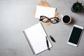 Flat lay modern minimal home workspace desk with blank notepad, glasses, smartphone, succulent plant, kraft envelope, paper card, Royalty Free Stock Photo