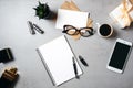 Flat lay modern minimal home workspace desk with blank notepad, glasses, smartphone, succulent plant, kraft envelope, paper card, Royalty Free Stock Photo