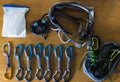 Flat lay of mountaineering pieces of equipment on a wooden table