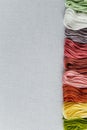 multi-colored mouline thread on a white canvas aida 16 counts, place for text