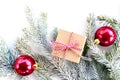 Flat lay new year cristmas pine tree, gift box and red balls on white Royalty Free Stock Photo