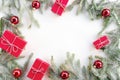 Flat lay new year red cristmas boxes, balls and pine tree with snow flakes Royalty Free Stock Photo
