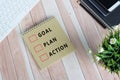 Flat lay of notepad with text goal, plan, action. Royalty Free Stock Photo