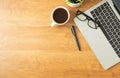 Flat lay of Office desk with laptop, and blank notepad with a coffee cup on wood table Royalty Free Stock Photo