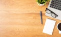 Flat lay of Office desk with laptop, and blank notepad with a coffee cup on wood table Royalty Free Stock Photo