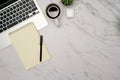 Flat lay of office essentials including earphones, coffee, and a blank notebook on work desk Royalty Free Stock Photo