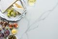 flat lay with olives camembert cheese wine and fruits arranged on white Royalty Free Stock Photo