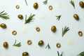 Flat lay olives, rosemary and oil spots on white background Royalty Free Stock Photo