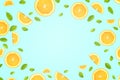 Flat lay of orange slices with green leaves on pastel blue background with gradient light on surface and copy space Royalty Free Stock Photo
