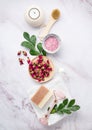 Flat lay with organic sea salt with dried rose flowers, soap, candle, brush and gua sha on a pink marble background. The concept Royalty Free Stock Photo