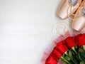 flat lay pair of pink Pointe Shoes, pearl beads, red roses on white background Royalty Free Stock Photo