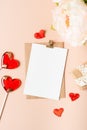 Flat lay of paper envelope with blank mockup greeting paper card. Pink table background with Valentine day gift, letter Royalty Free Stock Photo