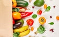 Flat lay paper shopping bag with assortment of fresh vegetables and fruits Royalty Free Stock Photo