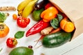 Flat lay paper shopping bag with assortment of fresh vegetables and fruits Royalty Free Stock Photo