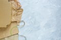 Flat lay of paper wastes as bags, boxes ready for recycling on gray background. Ecology care and social responsibility concept Royalty Free Stock Photo