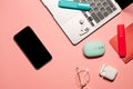 Flat lay on a pastel pink background with a silver laptop computer, smartphone with a touch screen, wireless mouse, earphones, Royalty Free Stock Photo