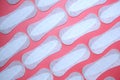 Flat lay pattern of clean unused sanitary woman pads on pink background Royalty Free Stock Photo