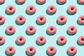 Flat lay pattern of tasty pink colorful donut on blue background Royalty Free Stock Photo