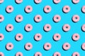 Flat lay pattern of tasty pink colorful donut on blue background Royalty Free Stock Photo