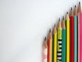 Flat lay of pencils are arranged vertically on a white background Royalty Free Stock Photo