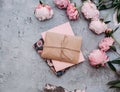Flat lay peony flowers with envelope. Beautiful flower composition.