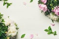 Flat-lay of peony flowers over white background, copy space