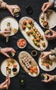 Flat-lay of people eating various sushi during japanese lockdown dinner Royalty Free Stock Photo