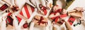 Flat-lay of peoples hands with Christmas gift boxes and decorations Royalty Free Stock Photo