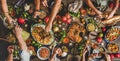 Flat-lay of peoples hands and Turkish foods over rustic table