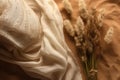 flat lay photo of beige scarf and dried flowers. background