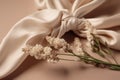 flat lay photo of beige scarf and dried flowers. background