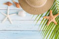 Flat lay photo coconut leaf and hat on wood background , top vie