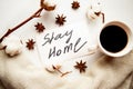 Flat lay photo with coffee card with message Stay Home on the table. Royalty Free Stock Photo